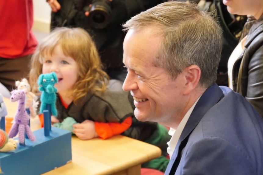 Bill Shorten sits with a girl after his childcare announcement in Melbourne on June 6, 2016.