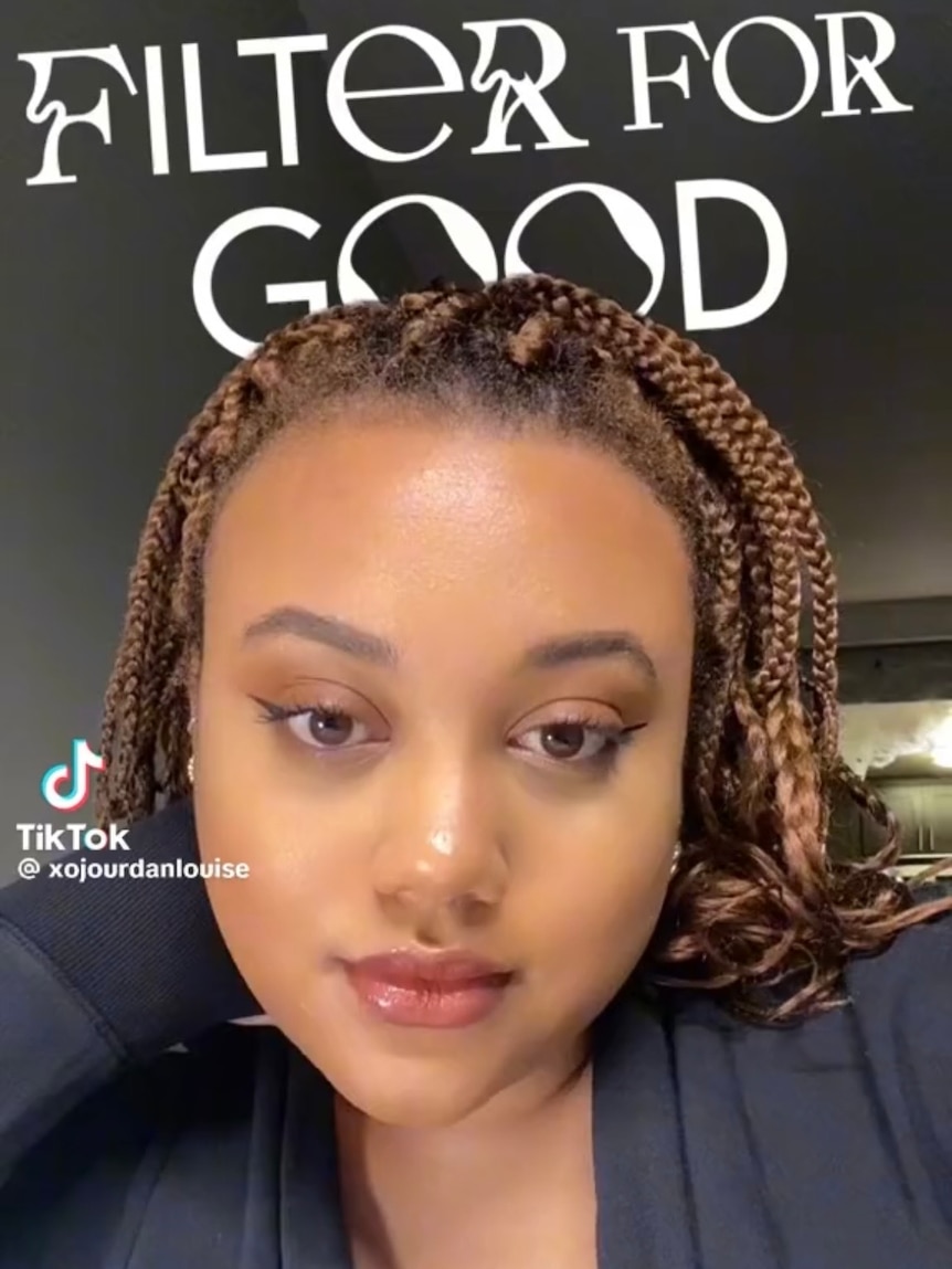 A young black woman making a TikTok, the text 'filter for good' above her.