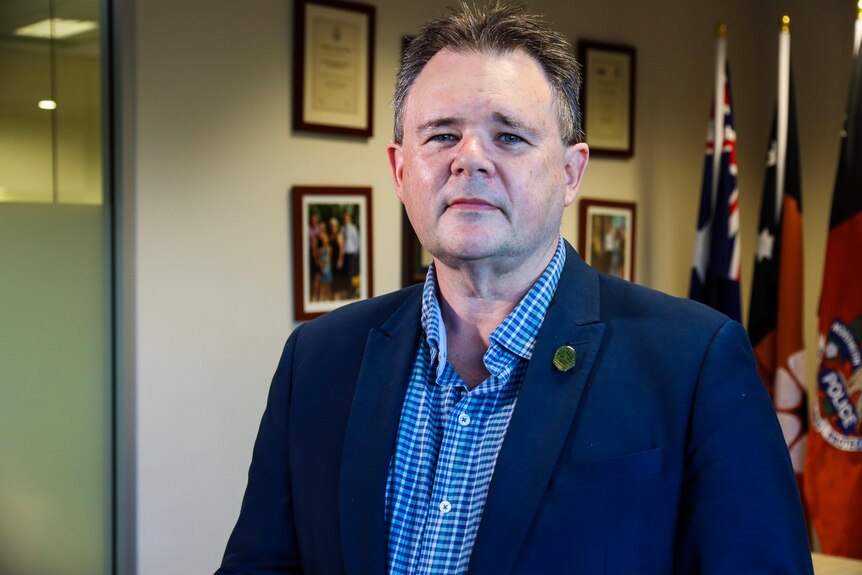 Northern Territory Police Association (NTPA) president Paul McCue looks directly at the camera in his board room. 