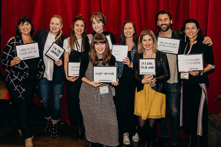 Group holding cards that say 'single-use sucks'.