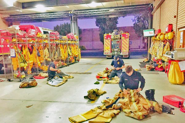 Fire crews after working through the night to contain the fire at Beechworth IGA.