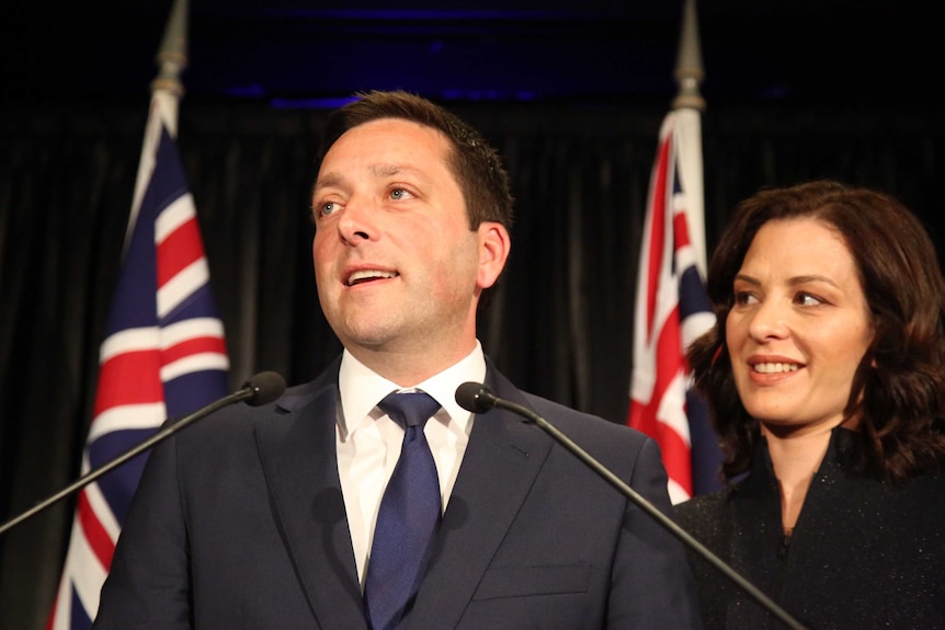 Matthew Guy looks out to the crowd with his wife Renae by his side.