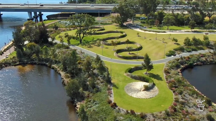 Aerial photo of parkland with serpentine wall throughout the park