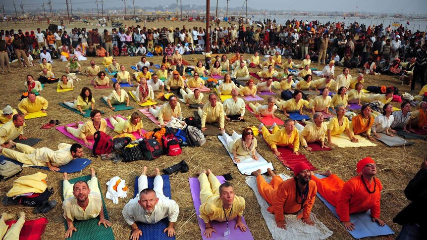 Foreign pilgrims practise yoga