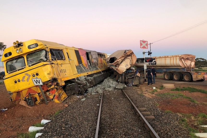 The aftermath of a train derailment caused by a road train.