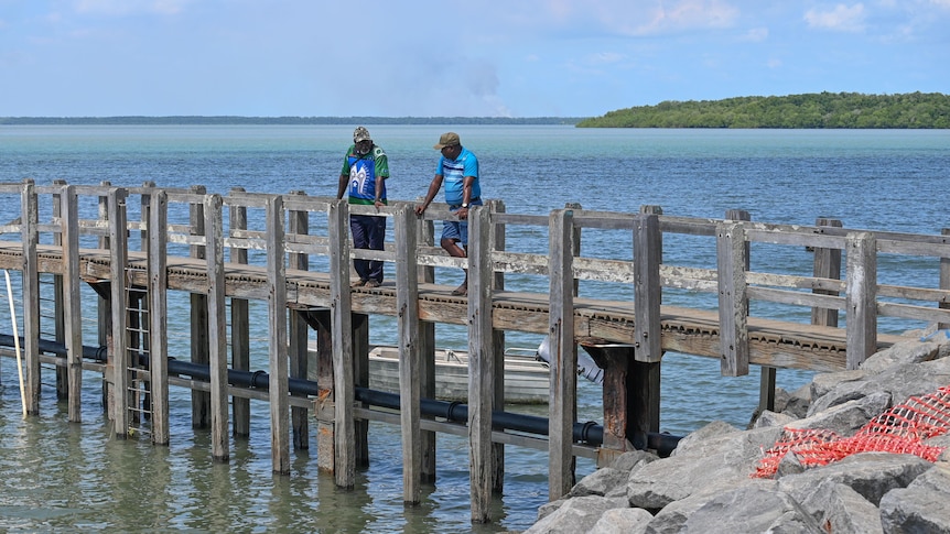 Two men standing on a jetty.