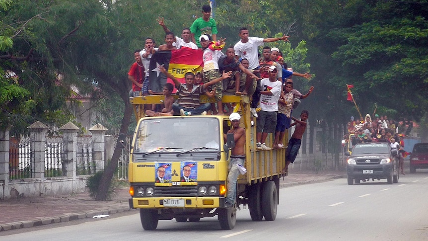 Supporters of Francisco Guterres drive through Dili.