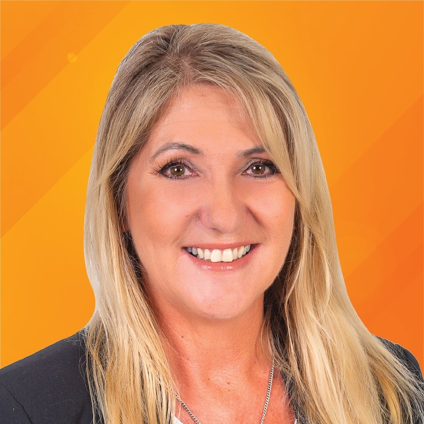 A woman with long blonde hair smiles against an orange background.