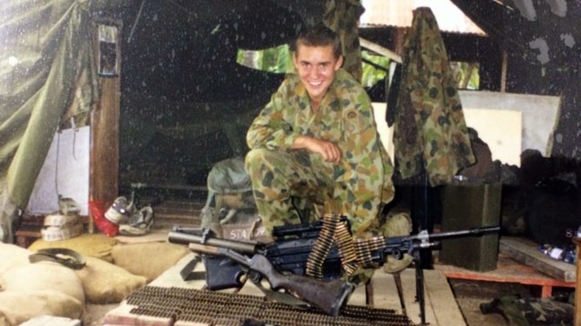 Michael Bush in his uniform with a gun