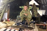 Michael Bush in his uniform with a gun