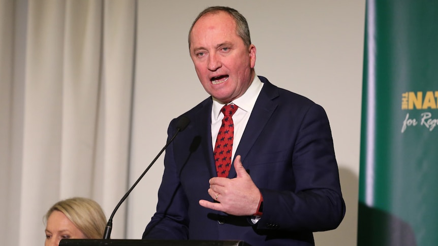 Barnaby Joyce raises a hand as he speaks at the Nationals' national party conference in Canberra.