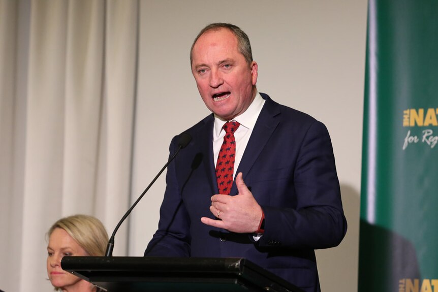 Barnaby Joyce raises a hand as he speaks at the Nationals' national party conference in Canberra.