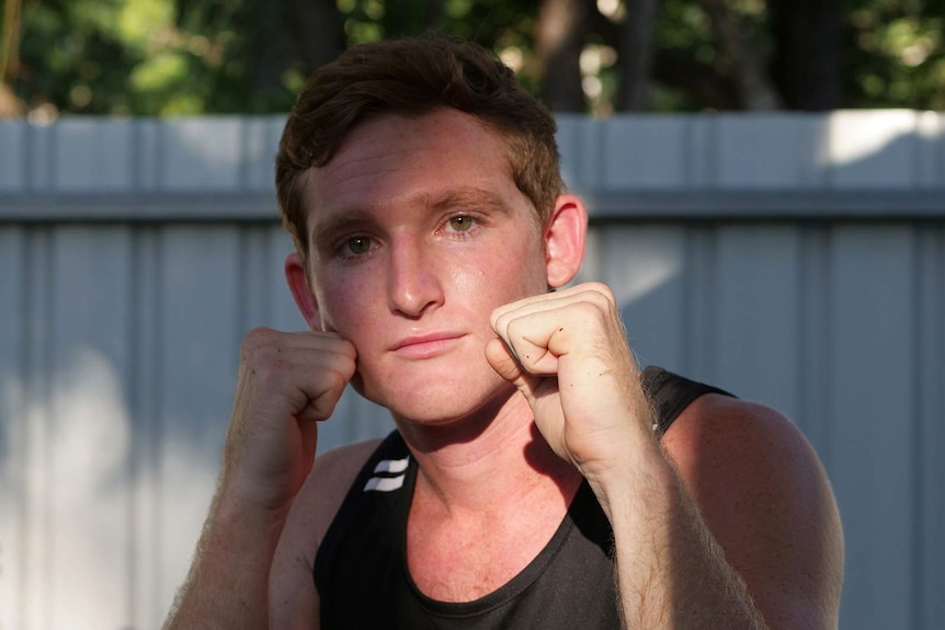 A photo of boxing trainer Ketch Crook with fists raised.