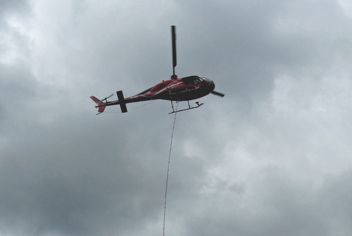The fire service is using a water bombing helicopter.