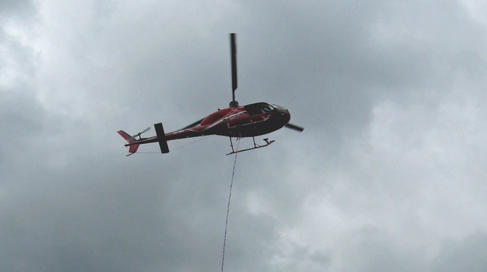 The fire service is using a water bombing helicopter.