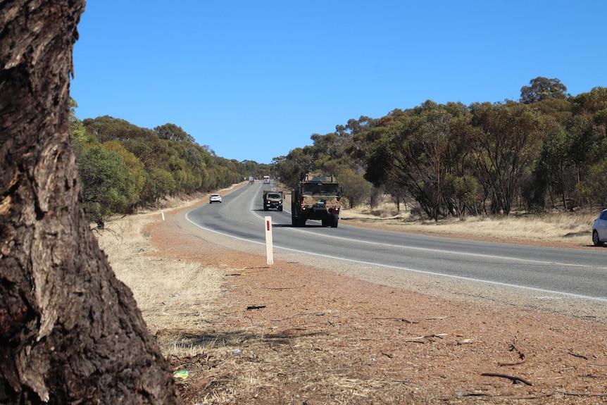 A section of Great Eastern Highway with trees on both sides of the road.