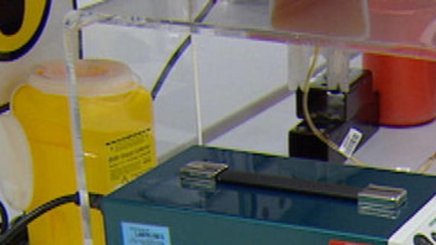 Generic TV still of laboratory worker filling blood bags in Brisbane. Good generic pic for blood supply stories.