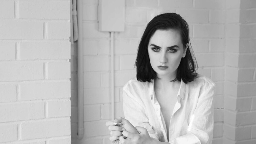black and white image of meg mac in a white shirt