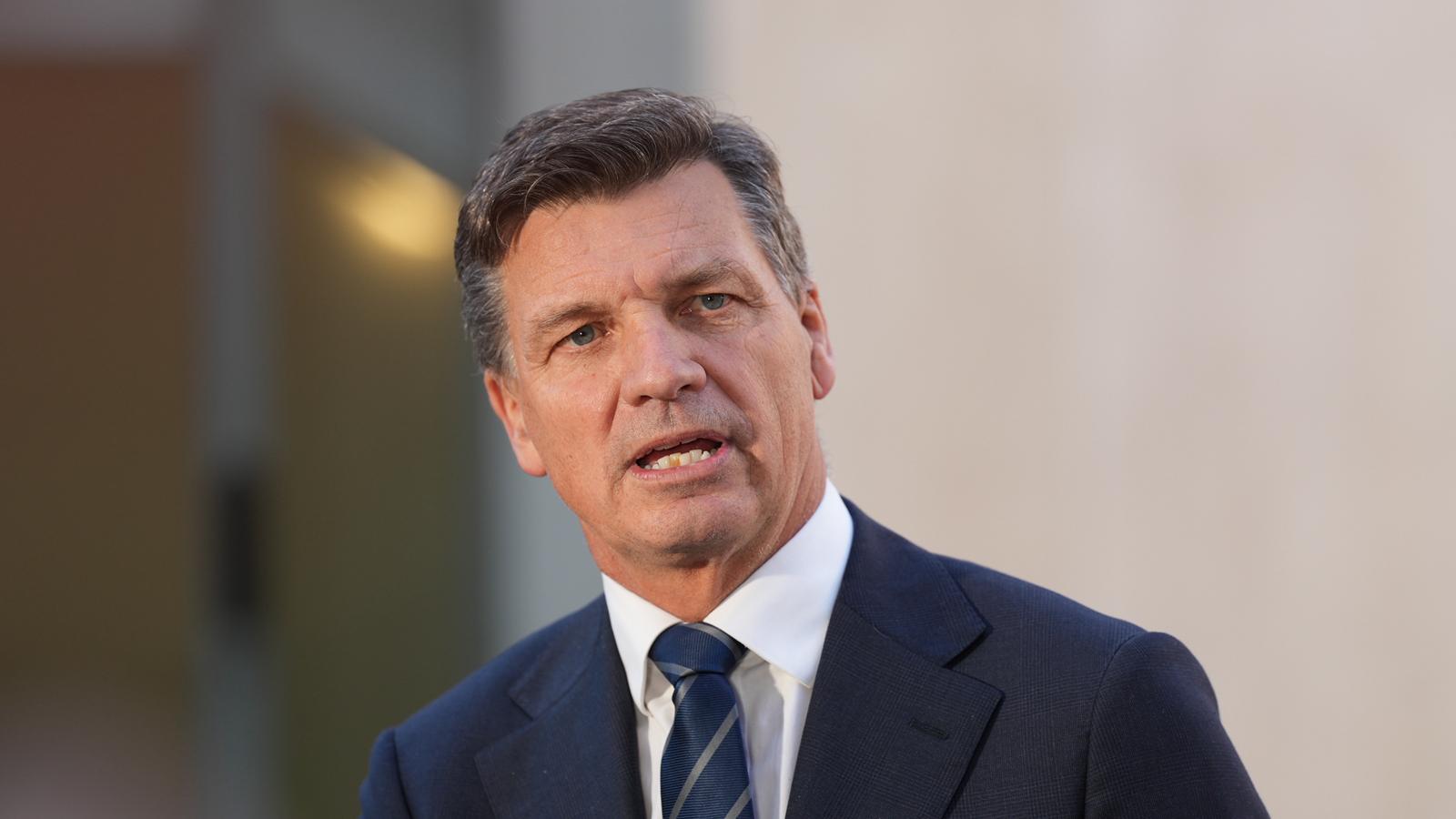 A man in a suit and tie with dark-coloured hair.