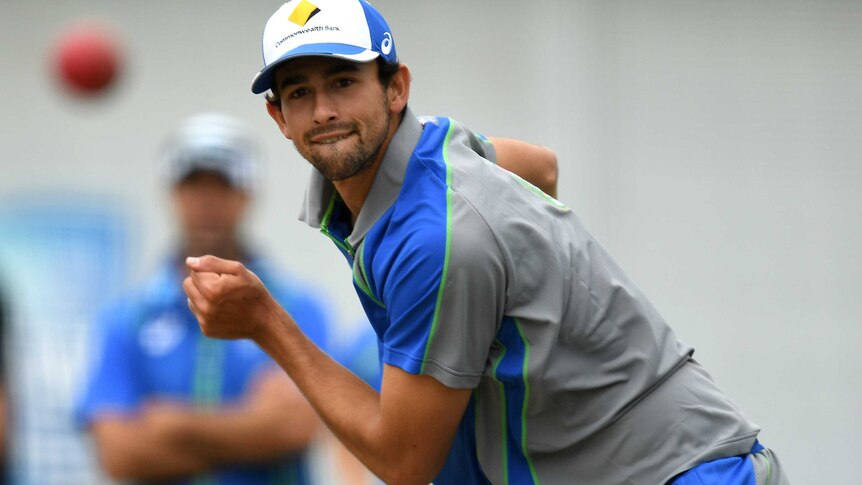 Ashton Agar watches a cricket ball in flight after bowling.