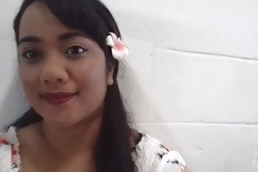 A young woman with a flower in her hair.