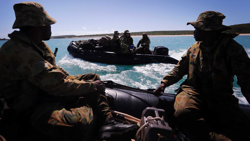 Soldiers from a NORFORCE patrol the coastline of Cotton Island in inflatable boats.
