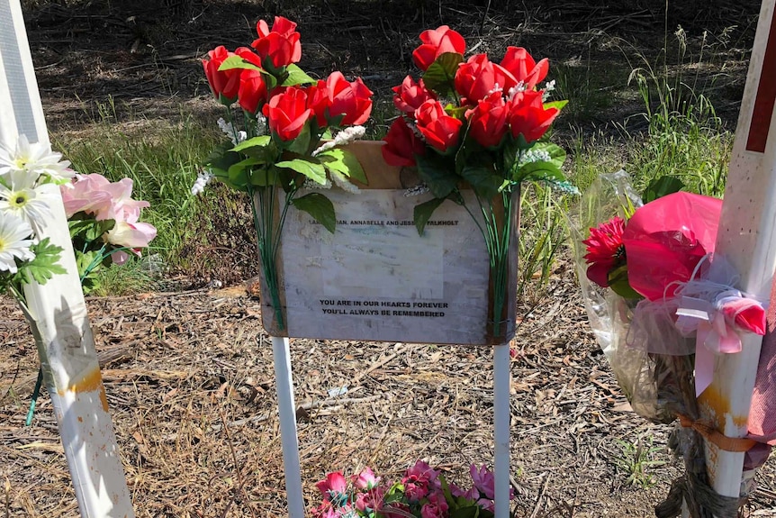 Flowers on a marble tribute that says "You are in our hears forever, you'll always be remembered".