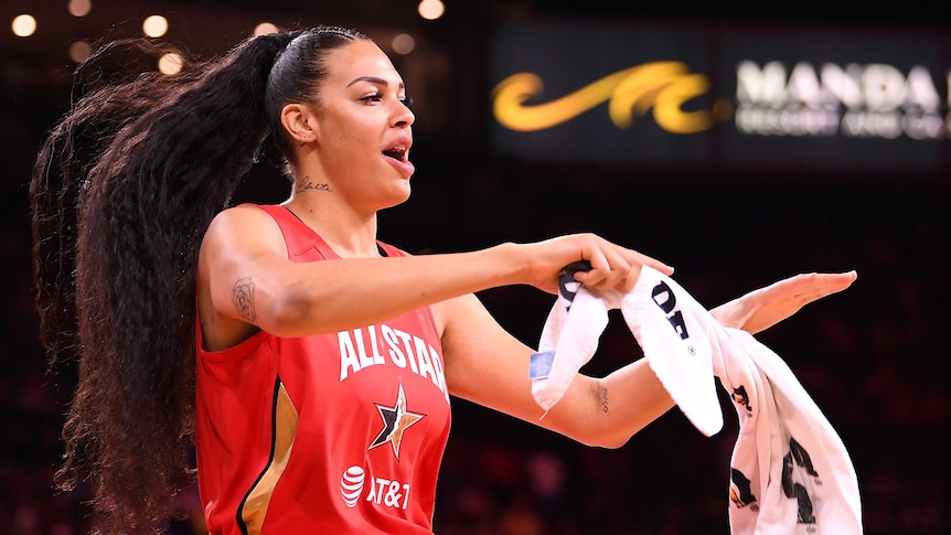 Liz Cambage holds a towel as she dances at the WNBA All Star Game.