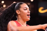 Liz Cambage holds a towel as she dances at the WNBA All Star Game.