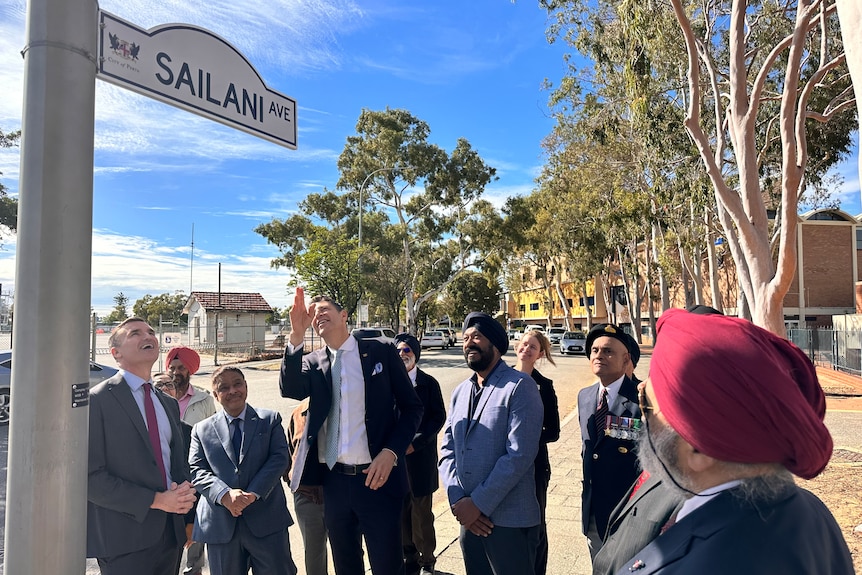 The Perth Lord Mayor points at the Saliani Ave street sign