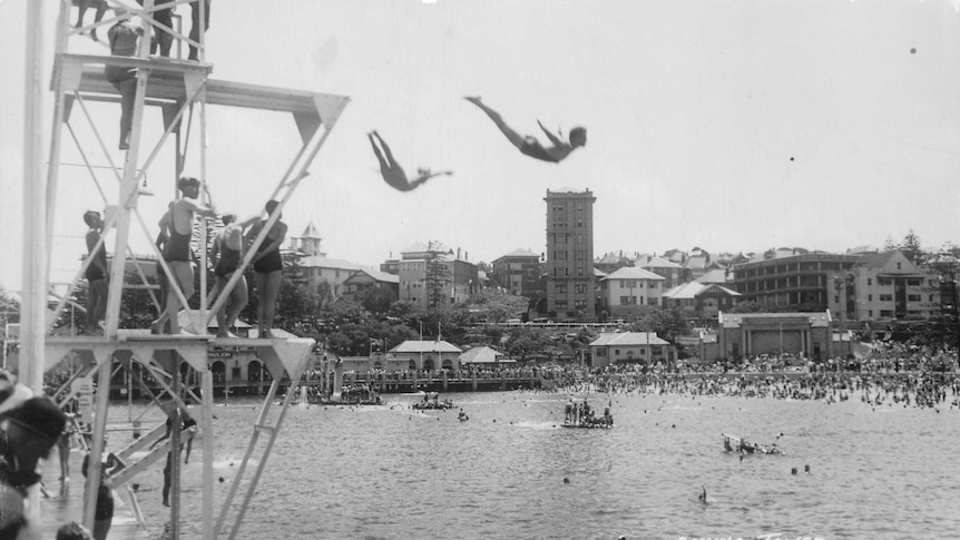 Old photo of two people diving off tower at Manly.