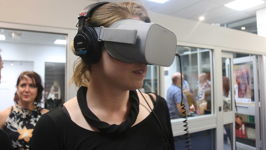 A woman is watching a film in virtual reality