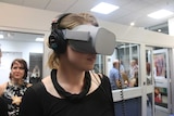 A woman is watching a film in virtual reality