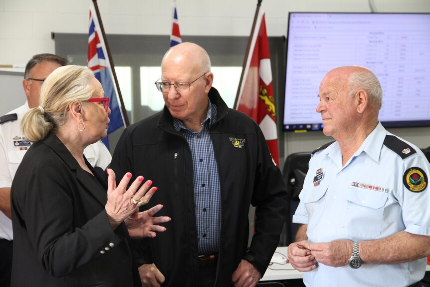 Mayor Miller speaking with the Governor General and an emergency service leader.
