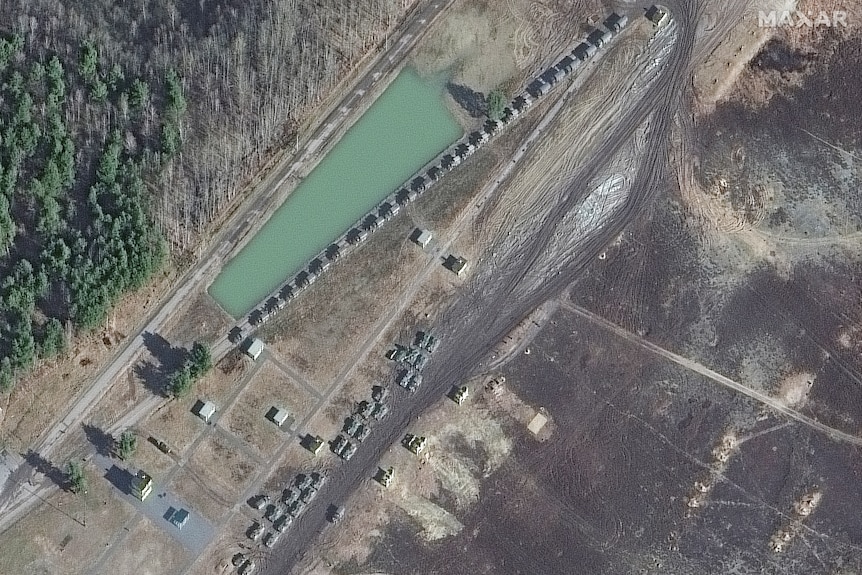 Military vehicles and equipment can be seen in an aerial view.
