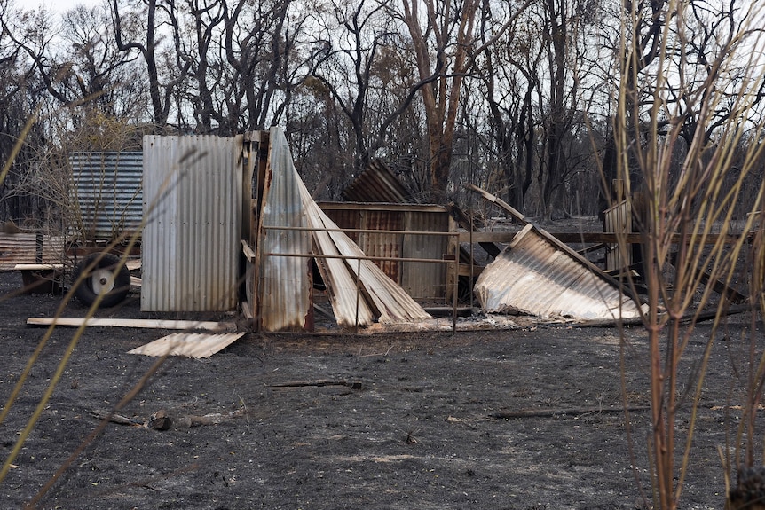 A collapsed horse shed destroyed by a bushfire