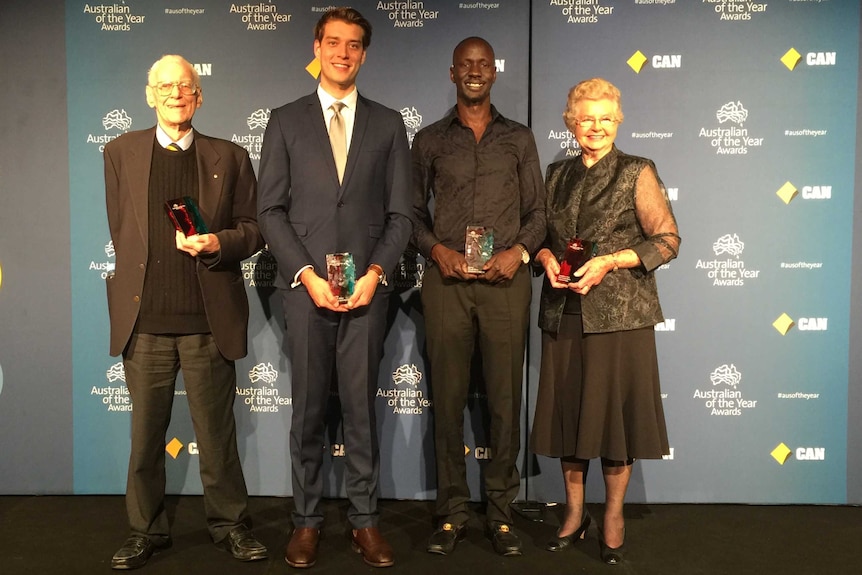 NSW Australian of the Year 2016 awards winners stand with their trophies.