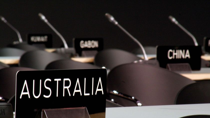 A nameplate with 'Australia' on it sits in the main (and empty) plenary hall at the Bella Centre
