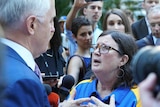 Woman confronts PM.