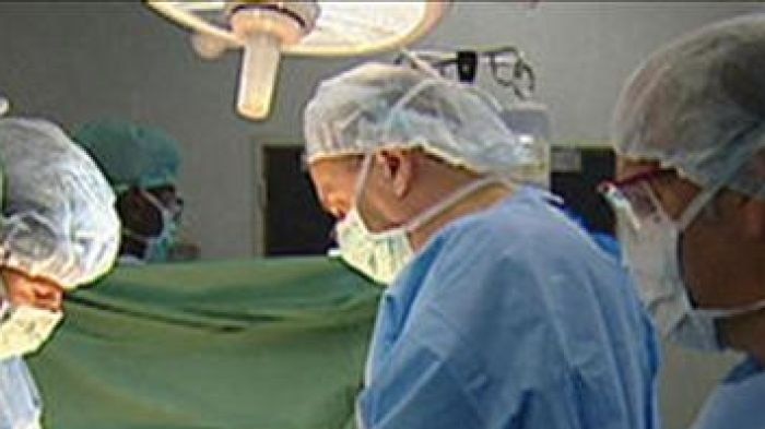 Surgeons operating in a theatre
