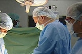 Surgeons operating in a theatre