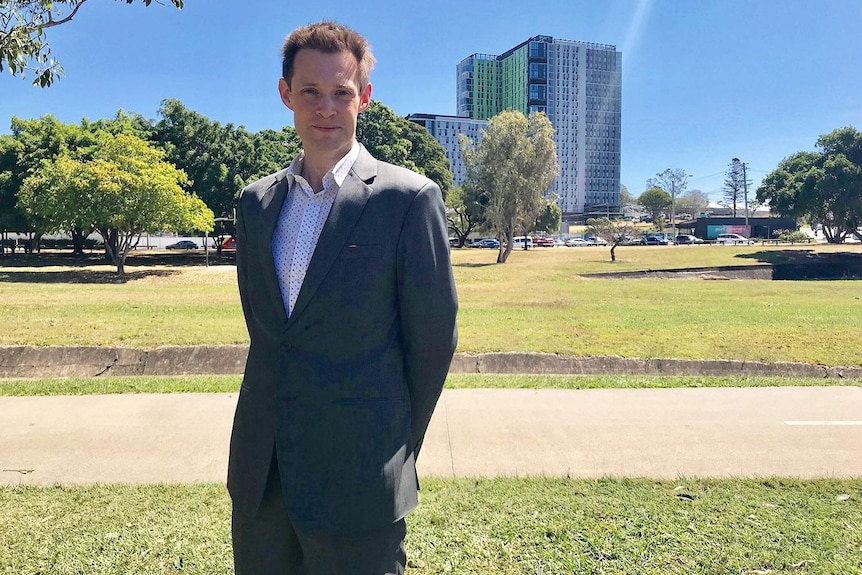 Dr Tony Matthews stands outside near the Park Central student accommodation buildings at Buranda in Brisbane.