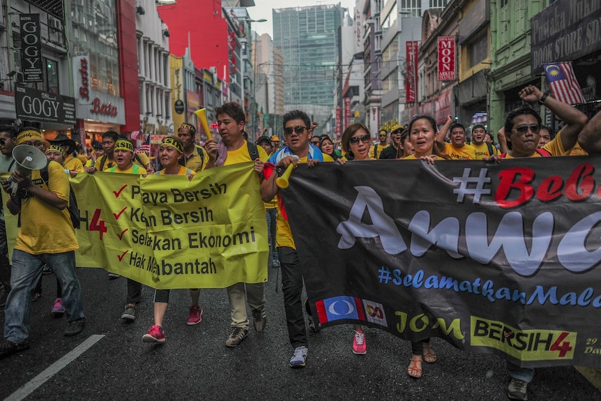 Protestors carry banners as they march on the second day of a demonstration