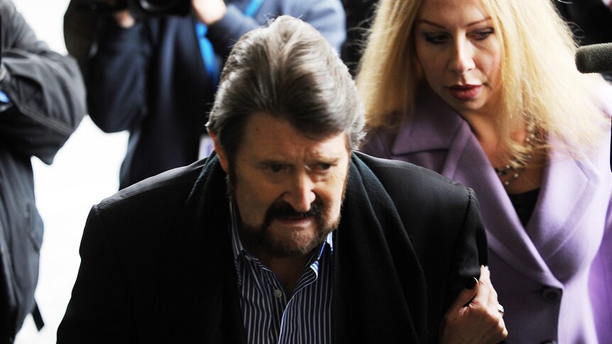 Broadcaster Derryn Hinch (left) and wife Chanel walk to the Melbourne Magistrates Court in Melbourne.