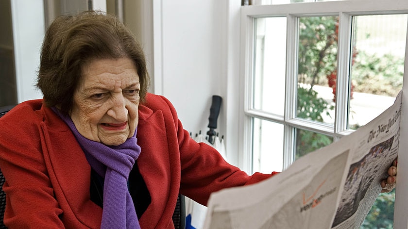 Journalist Helen Thomas reads through morning newspapers