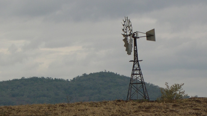 Old style rural windmill and dry grass near Gilgandra NSW. Generic rural scene.