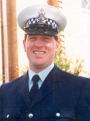 Constable Miller in his police uniform in front of blue background.
