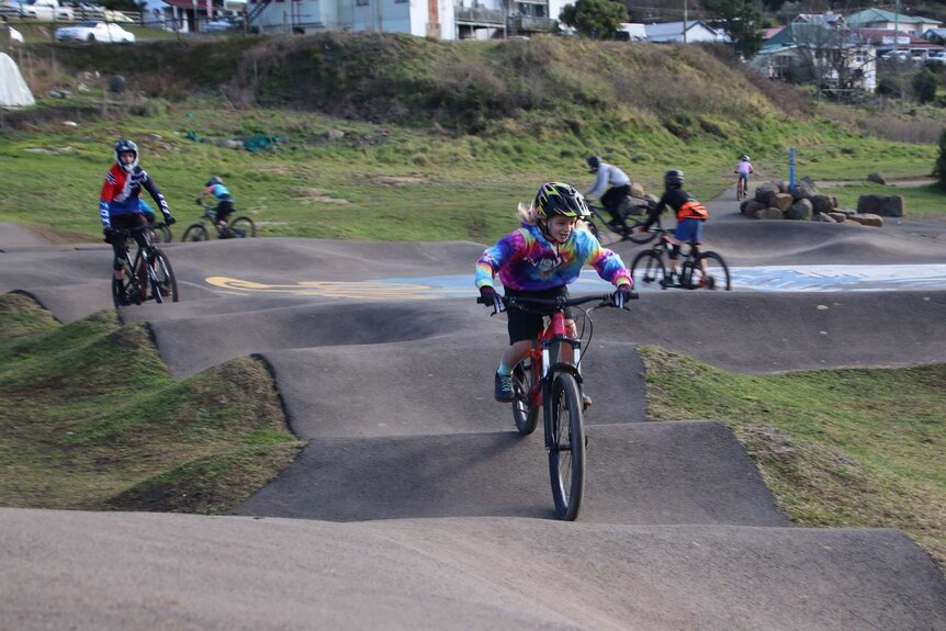 Young BMX riders on a track in Derby, Tasmania.