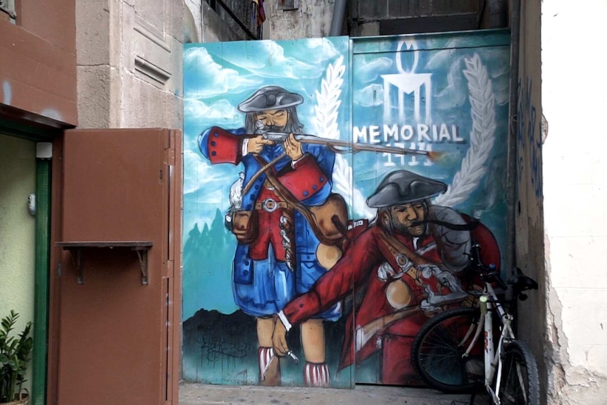 Graffiti in Barcelona depicts the 1714 defeat of Catalonian resistance to the Spanish.