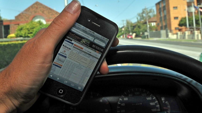 A driver uses a mobile phone while driving